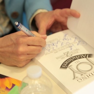Avadian signing Caregiving Book--Photo Courtesy Bonnie Keith