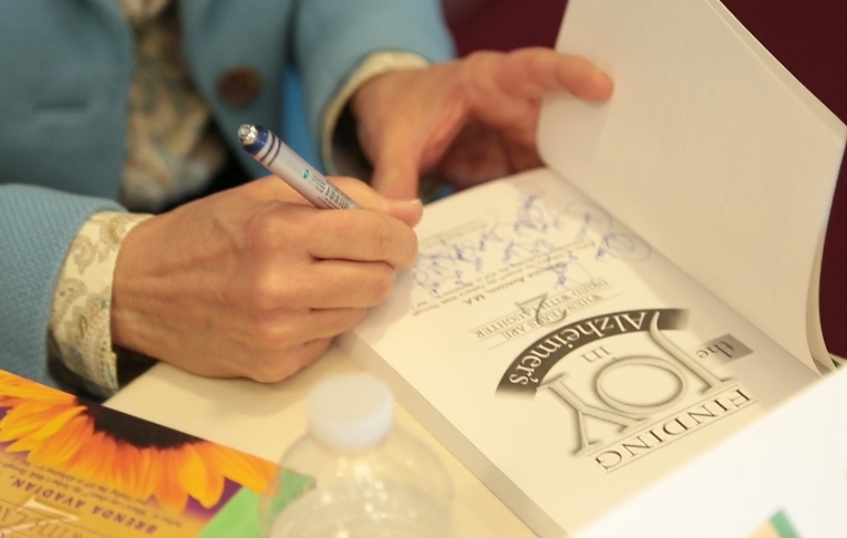 Avadian signing Caregiving Book--Photo Courtesy Bonnie Keith