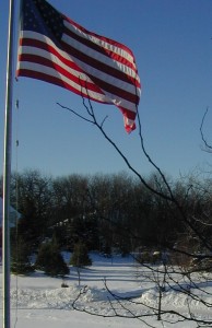 The U.S. Flag waves in front of my late uncle's home. He and my late aunt were WWII veterans. 