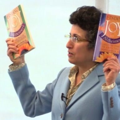 Brenda Avadian holds up two volumes of Finding the JOY in Alzheimer's