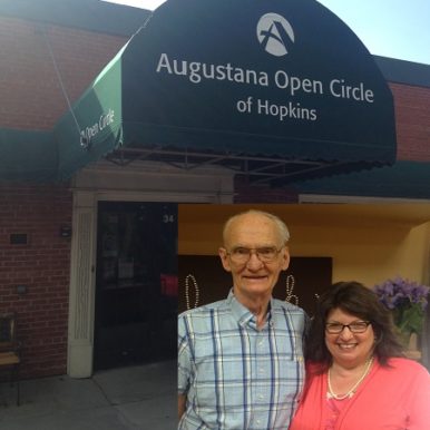 Sheri Zschocher and her husband Bob in front of the Augustana Open Circle Adult Day Services