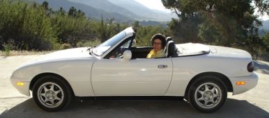 Brenda Avadian sitting in her Miata convertible