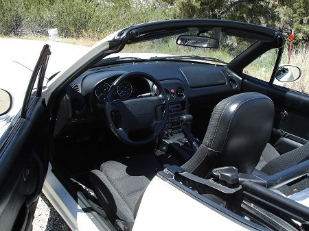 Image of Miata convertible with the top down and driver's side door open Avadian photo