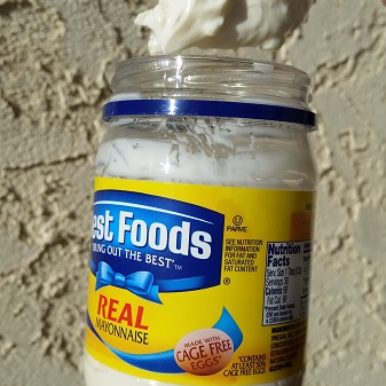 A spoonful of vanilla pudding in a mayonnaise jar