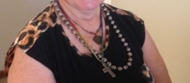 Val Schache of Australia in black sleeveless top with leapard print trim for VOICES with Dementia