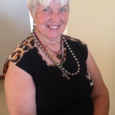 Val Schache of Australia in black sleeveless top with leapard print trim for VOICES with Dementia