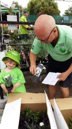 Granddaughter Harper and Alister Robertson working at the Garden Center before he was diagnosed with dementia