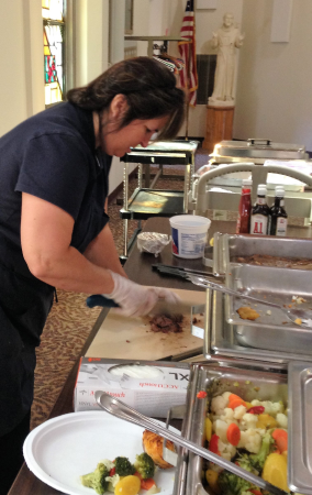 Bell Tower Residence Dietary coordinator chopping up food before placing on plate