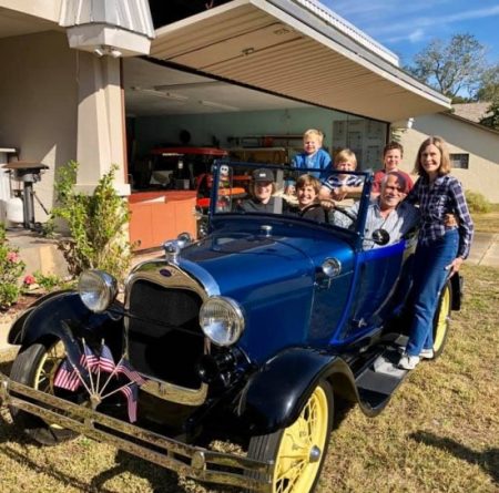 Bruce and Ann with 5 of their grandchildren in a 1928 Royal Blue Ford Roadster