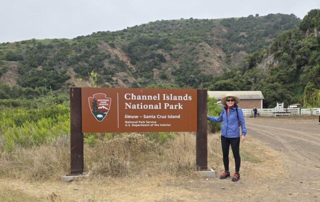 Brenda Avadian standing next to sign: Channel Islands National Park - Santa Cruz Island