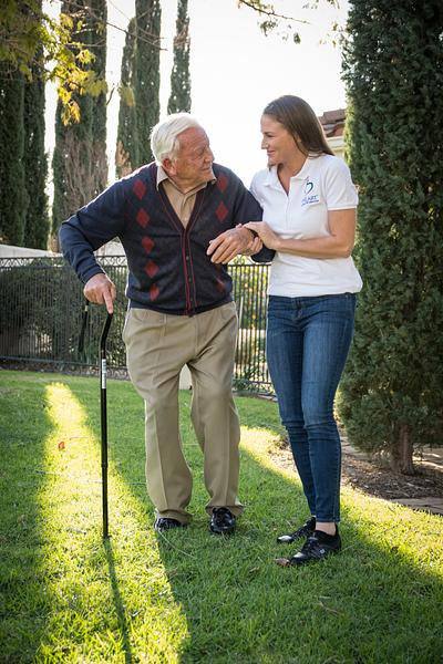 Aaron-Smith-A-caregiver-assisting-an-elderly-man-to-walk.