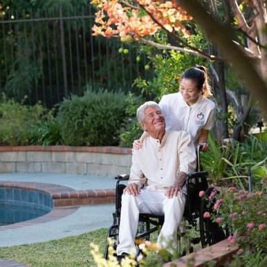 Aaron Smith - A caregiver pushing a man in a wheelchair